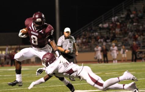 Senior Dior Traylor breaks a tackle against Ennis on Sept. 6. The Farmers take on Arlington tonight at home at 7:30 p.m.