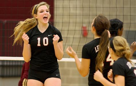 Junior Caitlin Gulyas celebrates with teammates during a home varsity volleyball match. The Lady Farmers open district play tonight on the road against Flower Mound.