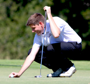 Senior Trevor Cash prepares to putt during the Guyer tournament at Oakmont Country Club on Sept. 30.