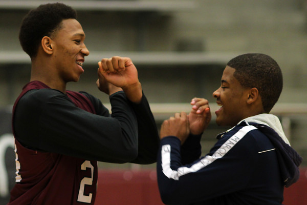 Senior Kaelin Love and junior Marquise Taylor share their pre-game handshake before Midnight Madness.