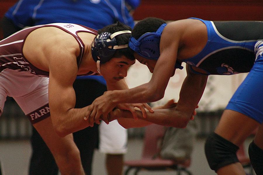Senior Armando Gonzales attempts to takedown his opponent first at the Grand Prairie/Kimball Tri.