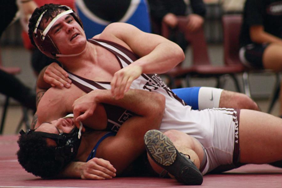 Senior Joe Head pins down his opponent during the Grapevine/Kimball Tri. 