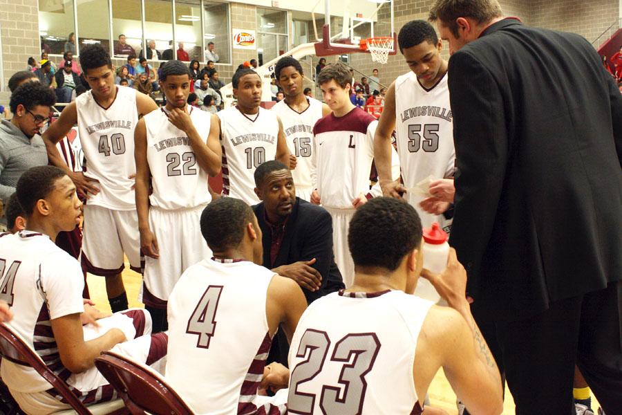 The team listens to their coachs words during the sixty seconds allotted during time-out on Feb. 11 against Marcus.