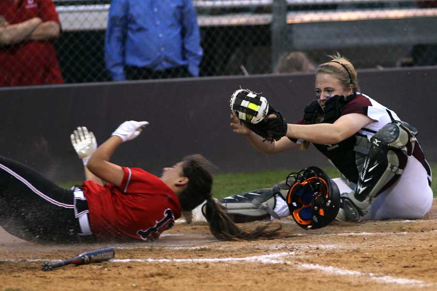 Senior Megan Haggard slides in to home to tag a Coppell player out on Tuesday, April 1.