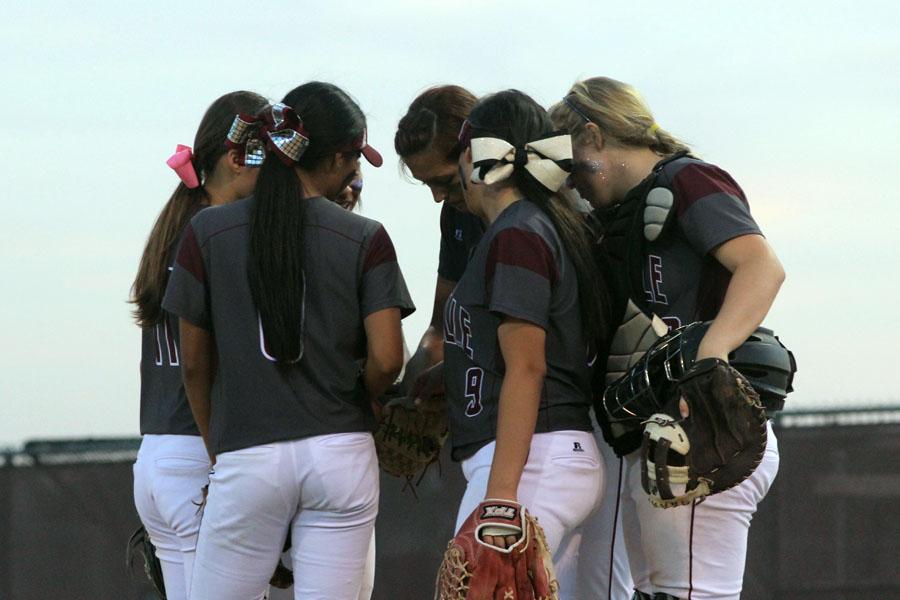 The team huddles by the pitching circle before the inning continues on April 25 against Euless Trinity.