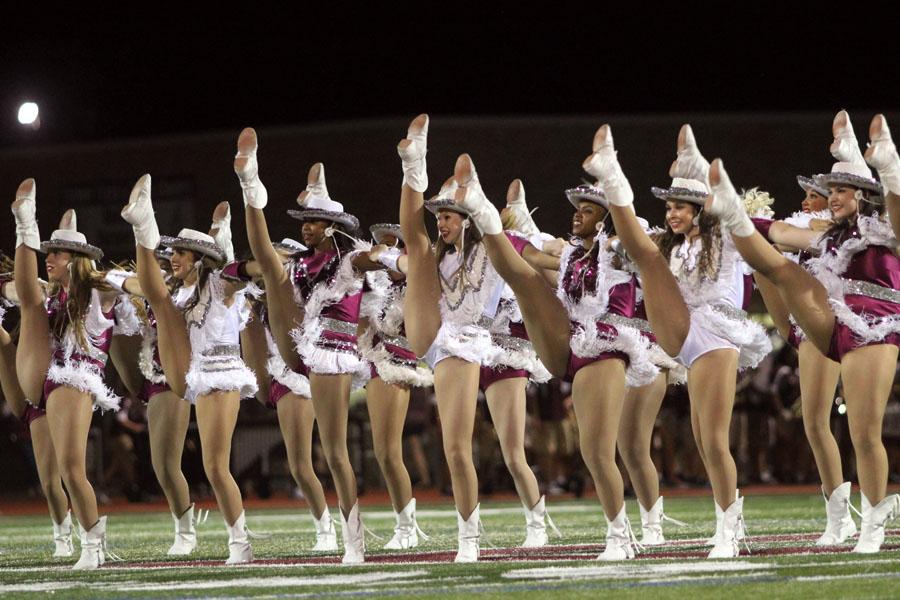 Farmerettes perform their kick routine during the halftime show.