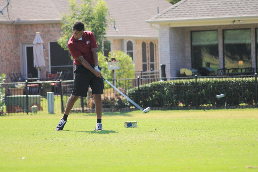 Senior Joel Mantgomery forcibly swings at the golf ball.
