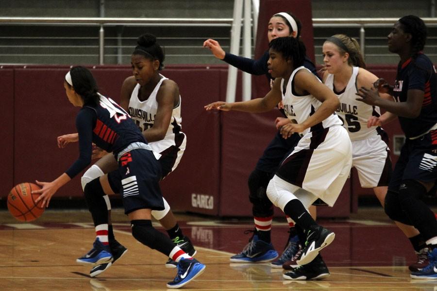 Freshman Kennedy Lankford, Sophomore Jakeiya Morgan and Junior Rebecca Huddleston attempting to get the ball back from the other team at the game against Allen on Jan. 23.  