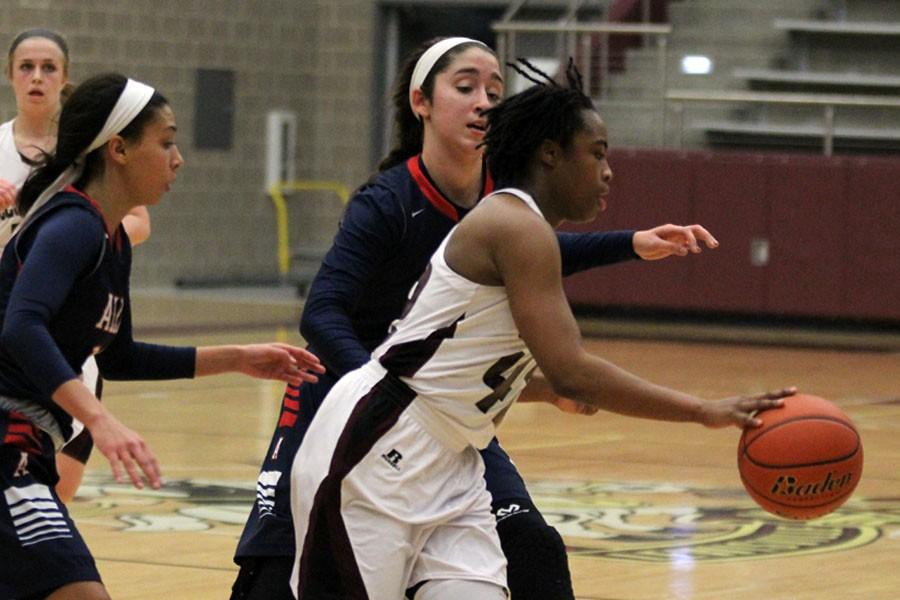 Sophomore Jakeiya Morgan attempting to go around the Allen players on Jan. 23.