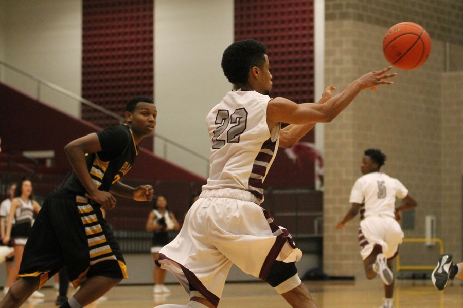 Senior Sean Guillory throws the ball to another teammate at the game on Feb. 3 against Plano West.