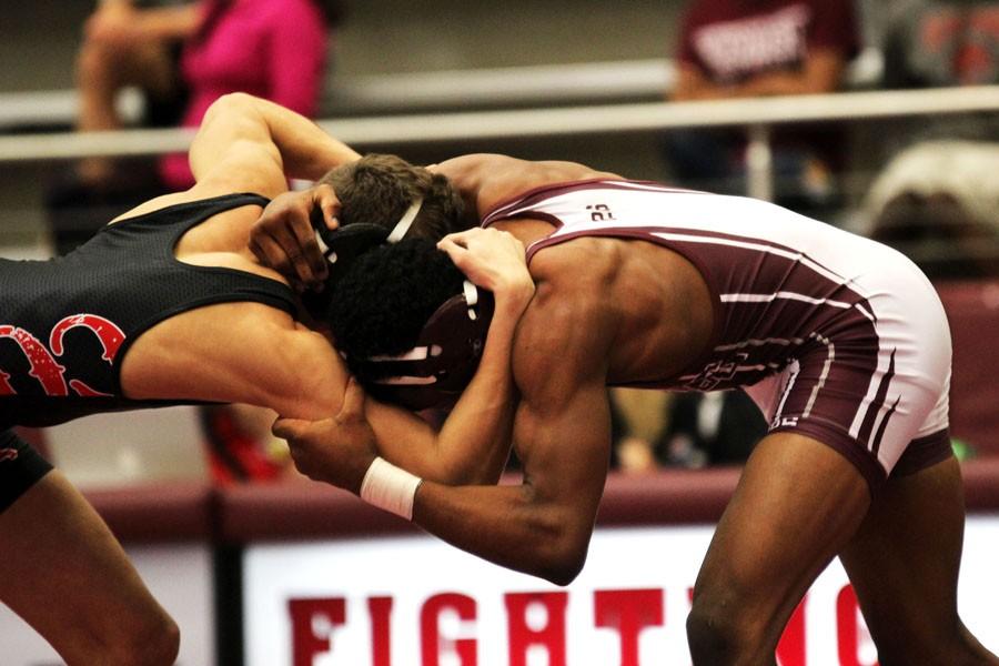Senior Xavier Franklin grapples with his opponent to get inside control.