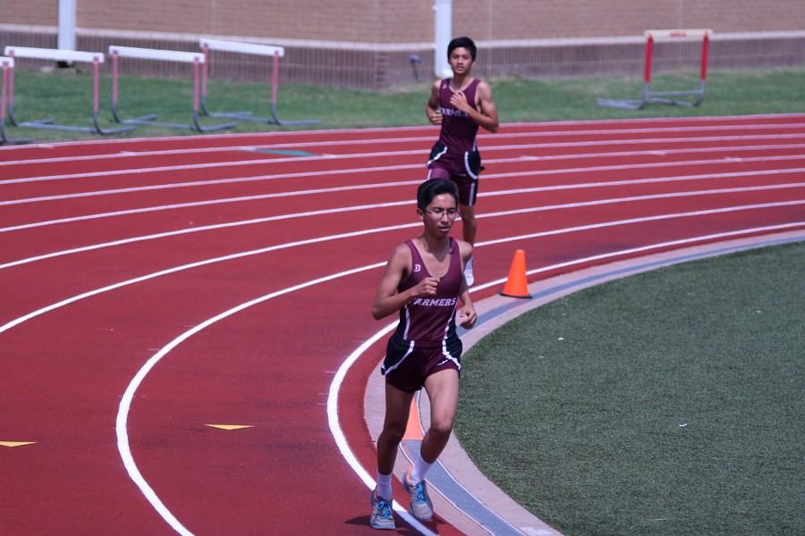 Freshmen Juan Pacheco in the lead and freshmen Christian Salazar run at the Track and Field Meet on April 9 at Marcus.