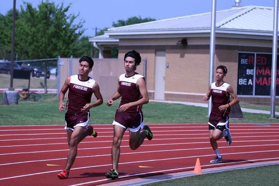 Junior Juan Calixto (left) junior Jesse Mena (middle) freshmen Esteban Del Campo (right) rush to the finish line after turning the last bend at the Track and Field Meet at Marcus on April 9. 