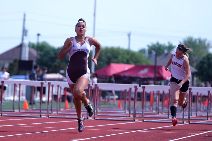 Sophomore Tiffany Vann jogs to the finish line finishing the hurdles at April 9, Track and Field Meet at Marcus.