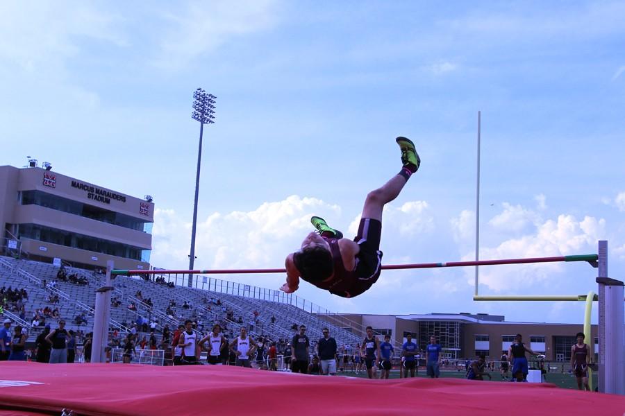 Freshmen Kevin Loza high jumps over a bar at the April 9 Track and Field Meet at Marcus.