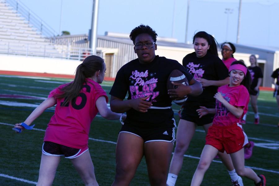 Brittany Marshall rushes up the field with the ball at the April 20 Powderpuff game.