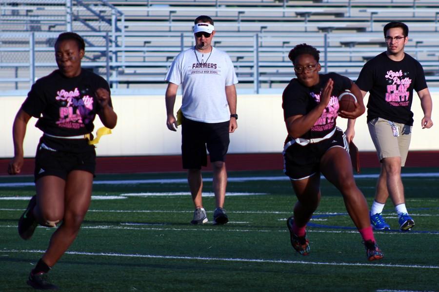Brittany Marshall rushes down the field with the ball on the April 20 Powderpuff game.