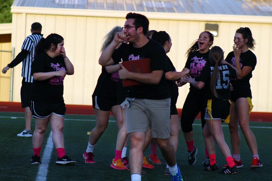 Haley Drake celebrates her own touch down with a group of fellow seniors and Coach ___ at the Powderpuff game on April 20.