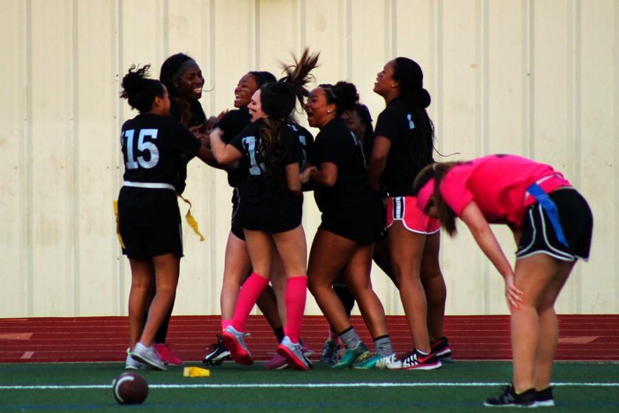 Seniors celebrate a touch down together at the April 20 Powderpuff game.