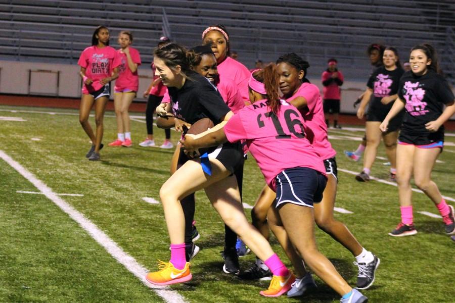 Alex Shumway rushes up the hall field trailed by four Junior girls at the April 20 Powderpuff game at Goldsmith Stadium.