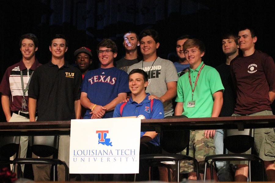 Outfielder Nick McGuire sits surrounded by the baseball team after signing to Louisiana Tech.