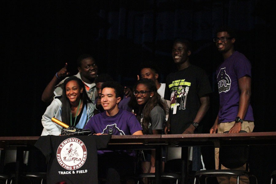 Justin Bubak poses for a picture with friends and teammates after signing. 