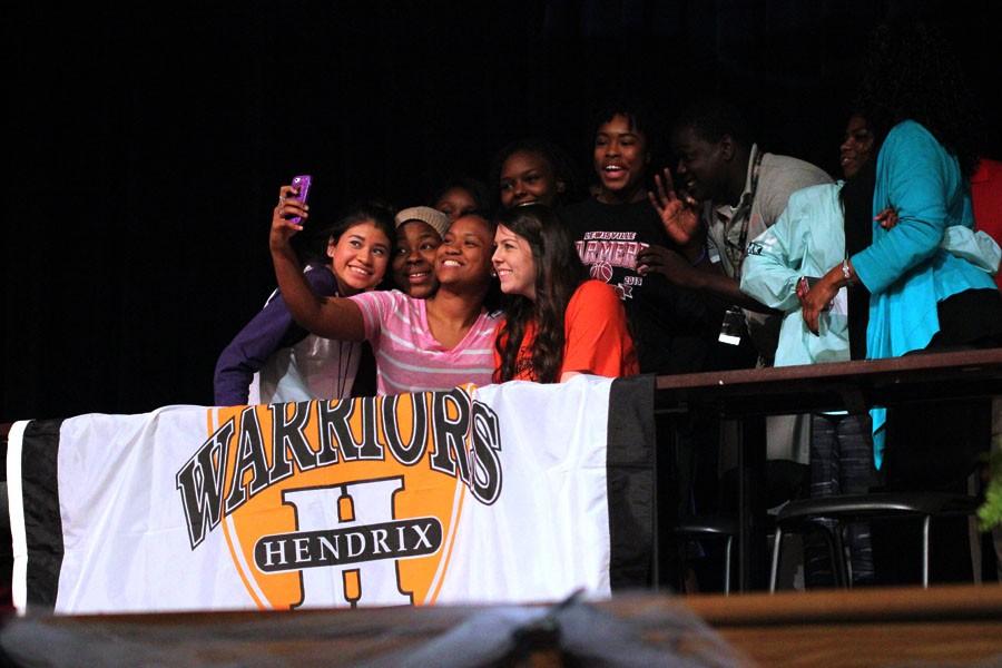 Basketball forward Alex Shumway takes a selfie with friends after signing to Hendrix College.