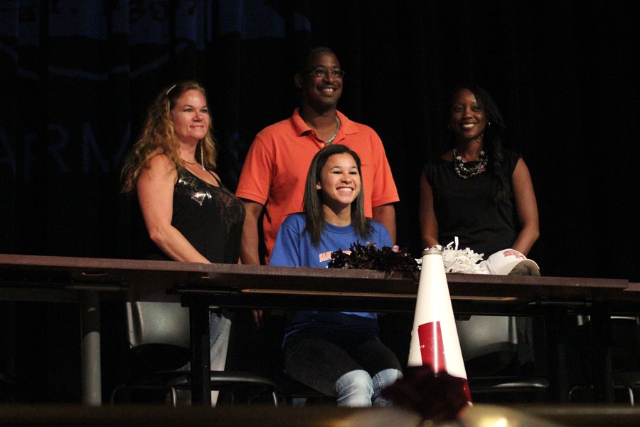 Cheerleader Sydney Williams smiles into the crowd after signing to Sam Houston State.