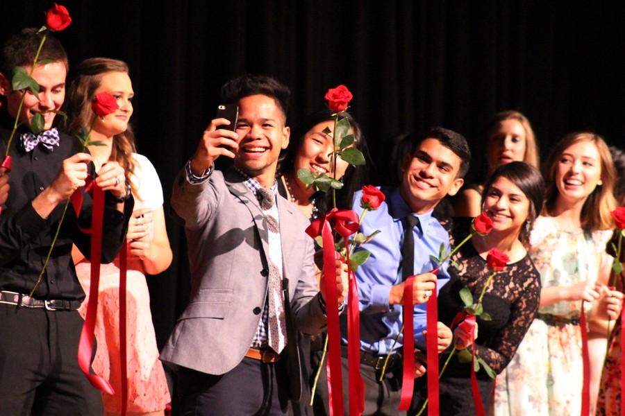 Senior David Crowell takes a selfie with his friends on stage after rosecutting on May 19 at the Leo C. Stuver auditoirum. 