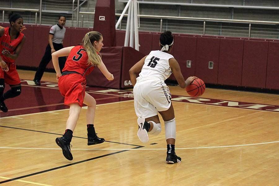 Sophomore McKenzie Bowie (15) dribbles the ball toward the hoop during the game against Frisco Liberty on Nov. 9.