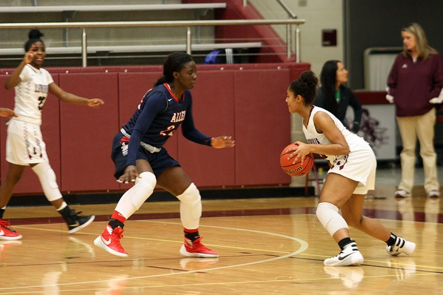 Sophomore McKenzie Bowie (15) crosses an Allen player in an attempt to make a better shot.