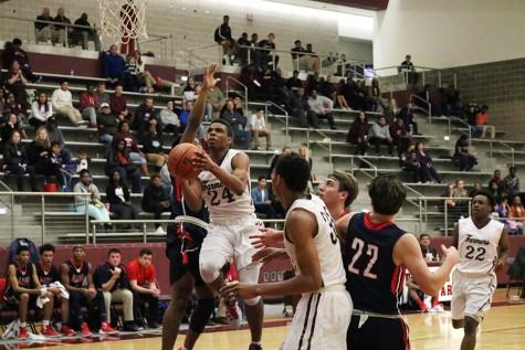 Senior Emeka Eni (24) attempts a lay up during the Allen game on Jan. 22.