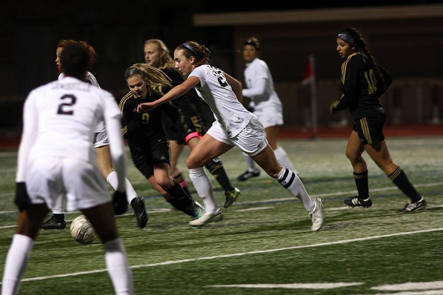 Senior Carli Arthurs (20) attempts to outrun the defender who tries to steal  the ball.