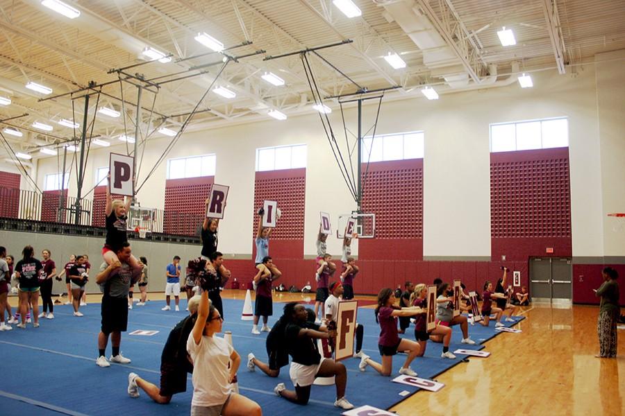 Coed cheer members practice on Jan. 7 for their upcoming competition.