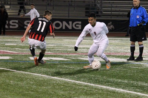 Junior Peter Hmung surpasses junior Kyle Pellino from Marcus in an attempt to score a goal during the game on Jan. 15.