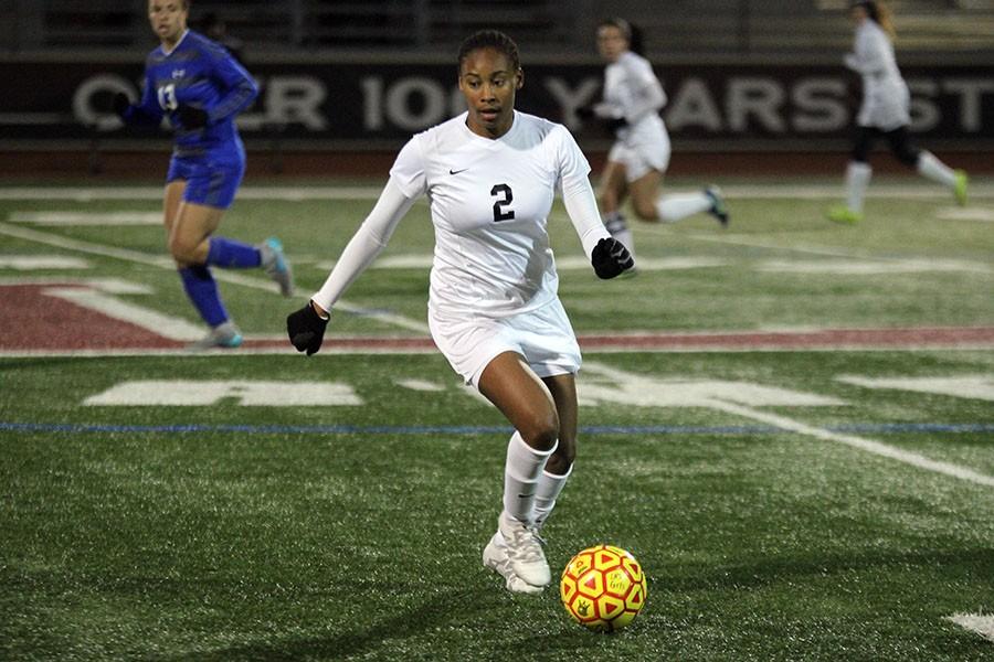 Senior Bria Williams (2) is dribbling down the sideline headed to the goal.