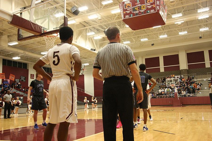 Senior Aubreion Bobb (5) stands by the ref to see the close free throw.