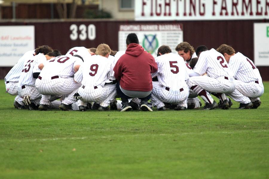 Last+years+Farmer+baseball+team+huddles+before+the+game+against+Hebron+on+March+14.+
