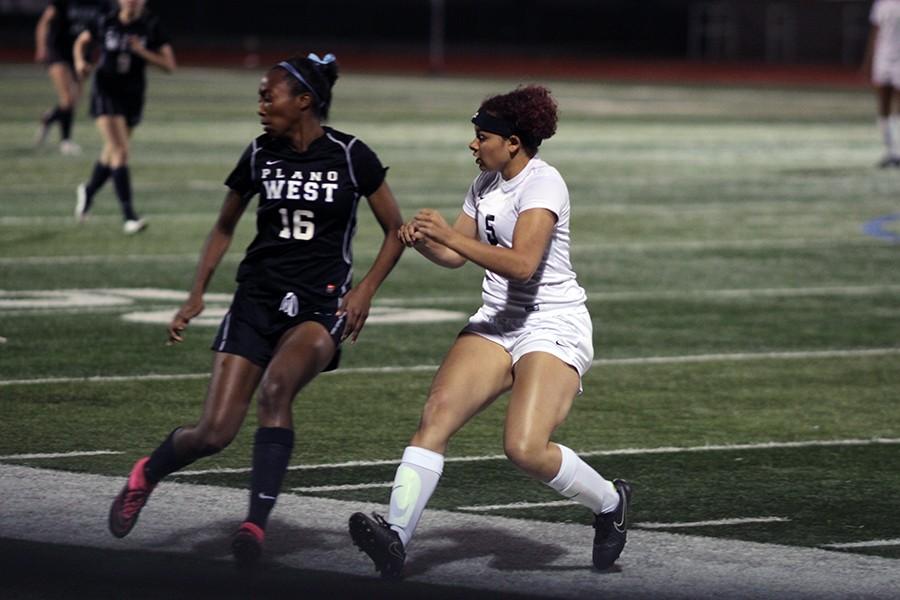 Myah Buhlar #5 dodging an opponent on the Plano West team to try and get the ball faster then her.