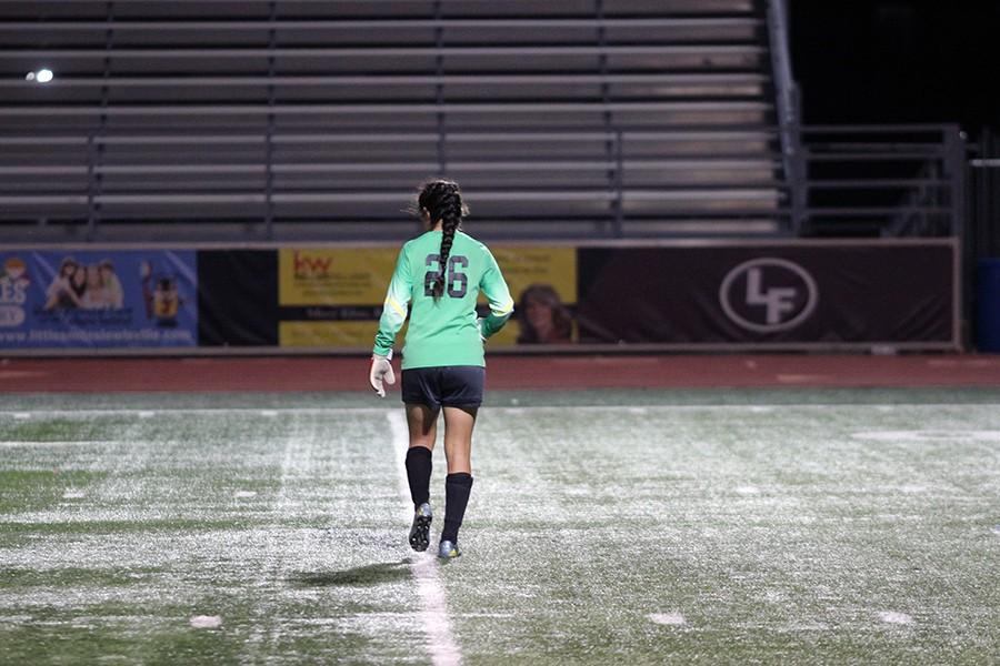 26, senior, goalie going back to her post to guard the goal