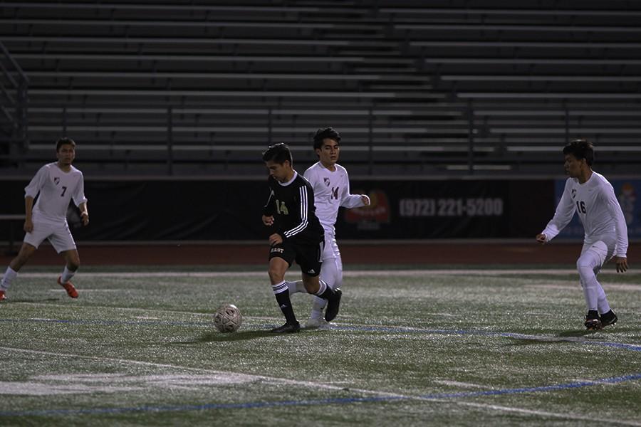 Carlos Ronquillo, #10, Julio Gomez, #7, Pedro Lopez, #16, run up behind a player from the Plano East team on the night of March 14