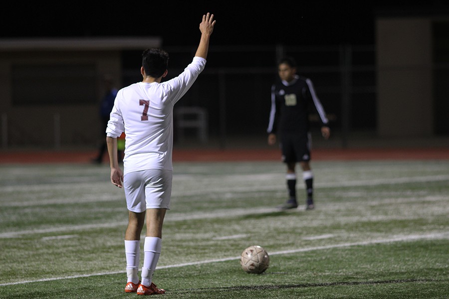 Julio Gomez, #7, prepares to kick the ball in the game against Plano East on March 14.