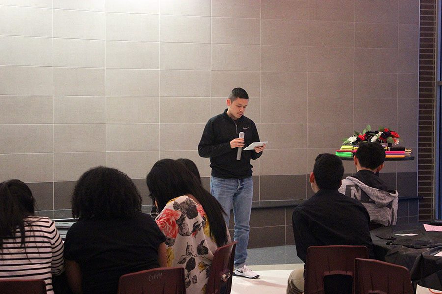 Junior Victor Avila reads his poem, The Problem With Humanity, to the audience.