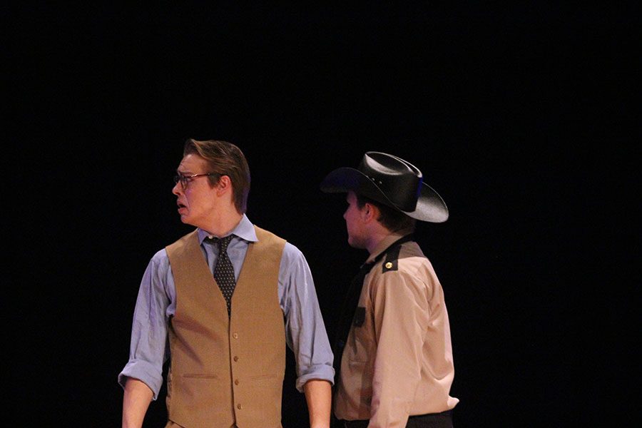 Atticus, played by senior Tallon Coxe, becomes startled when Mayella Ewell testifies false statements, while Heck Tate, played by junior Camron Baker, stands by.