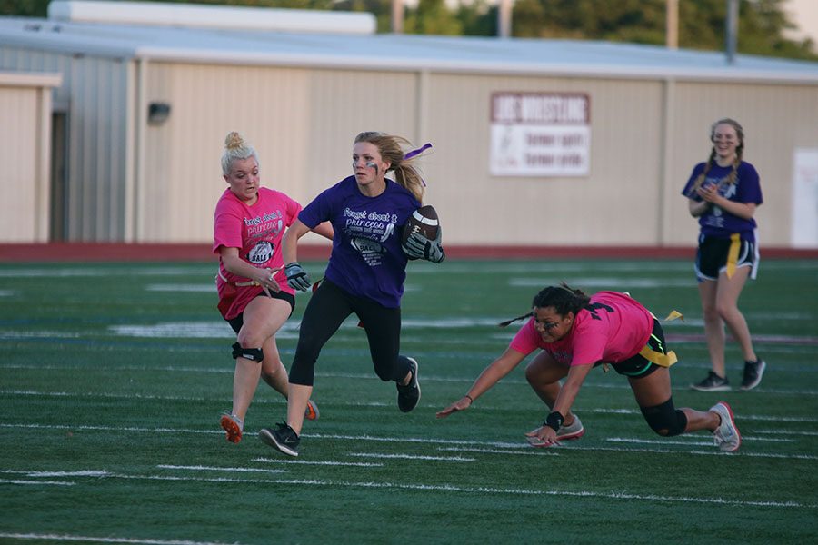 Senior Lindsay French runs down the field as junior Madison Visser attempts to stop her. 
