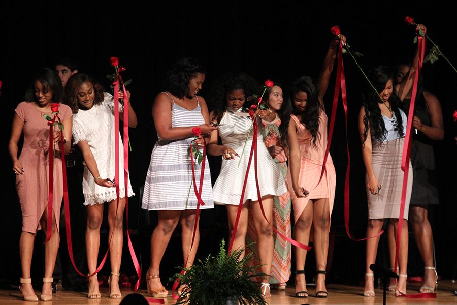 A group of senior girls cut their roses during the rosecutting ceremony on Tuesday, May 17.