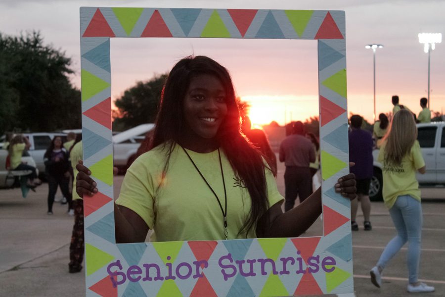 Senior Lovelyn Okoro poses for a picture with the sunrise.