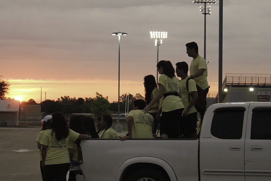 Seniors gather in the back of a friends truck to enjoy the sunrise. 