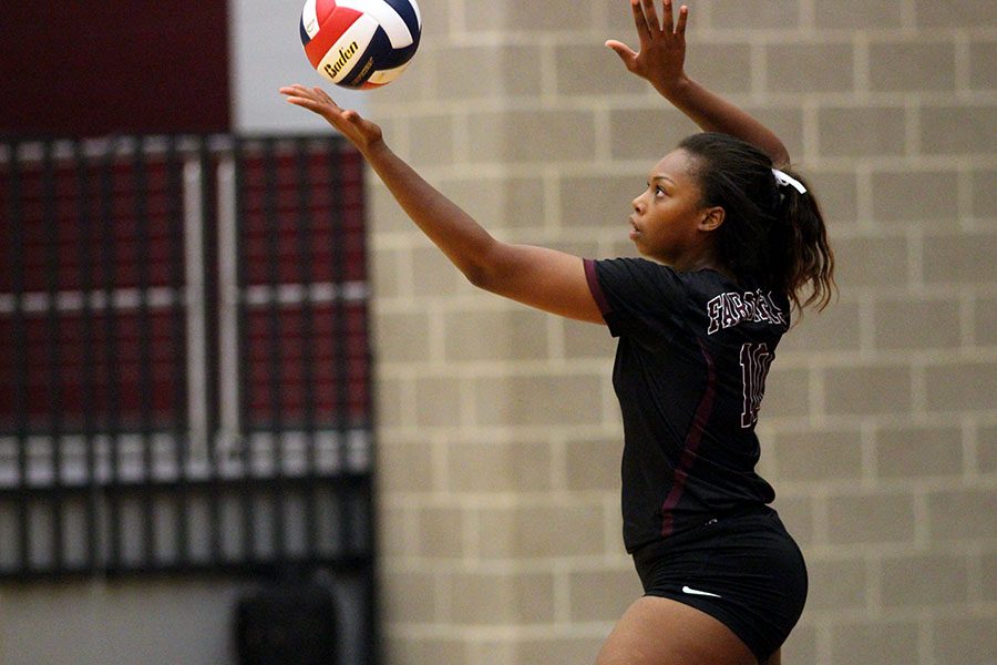 Senior Jayda Gibson (10) tosses the ball into the air in order to serve.