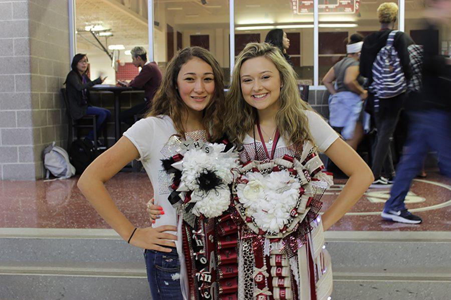 Juniors Anna Calderon and Brynlee Devercelly show off their mums for mum and garter day on Thursday, Oct. 20.